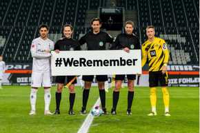 Players holding #weremember sign
