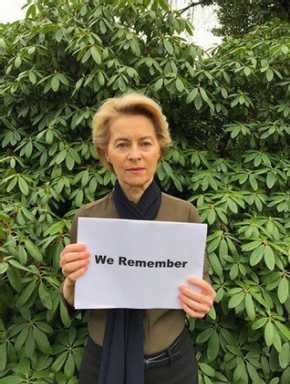 Woman holding #weremember sign
