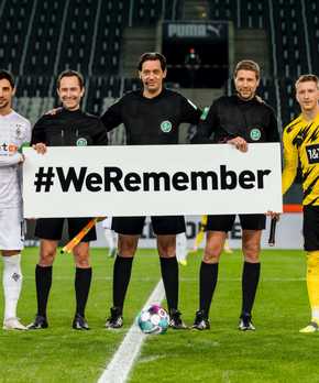 Football players on game with #weremember sign