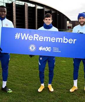Football players with #weremember sign